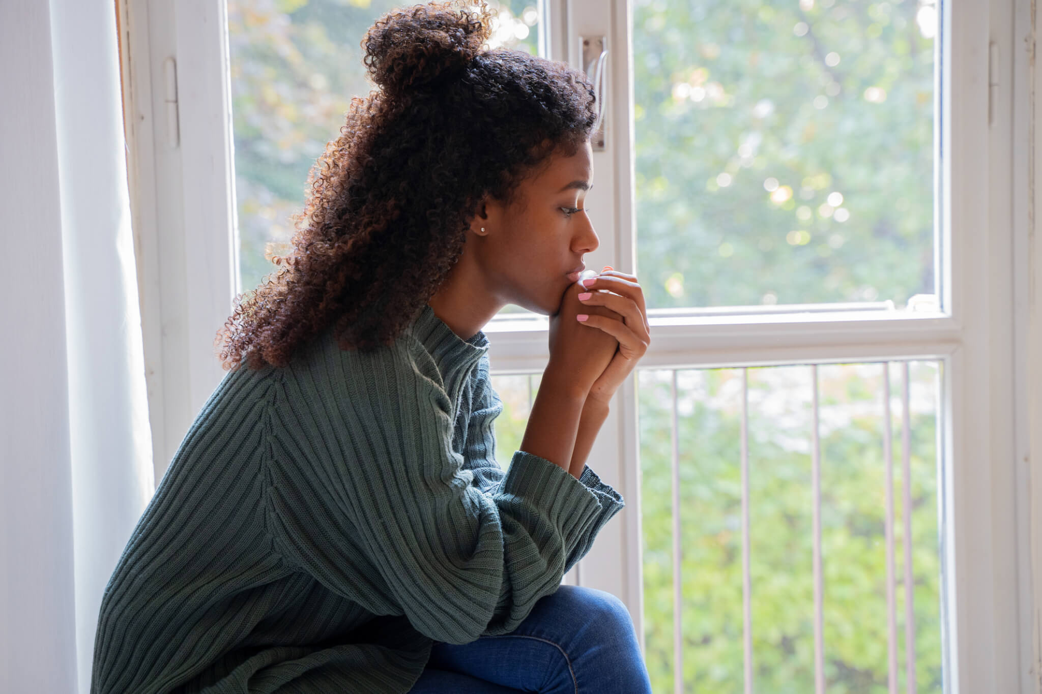 Black woman feeling depression symptoms alone at home